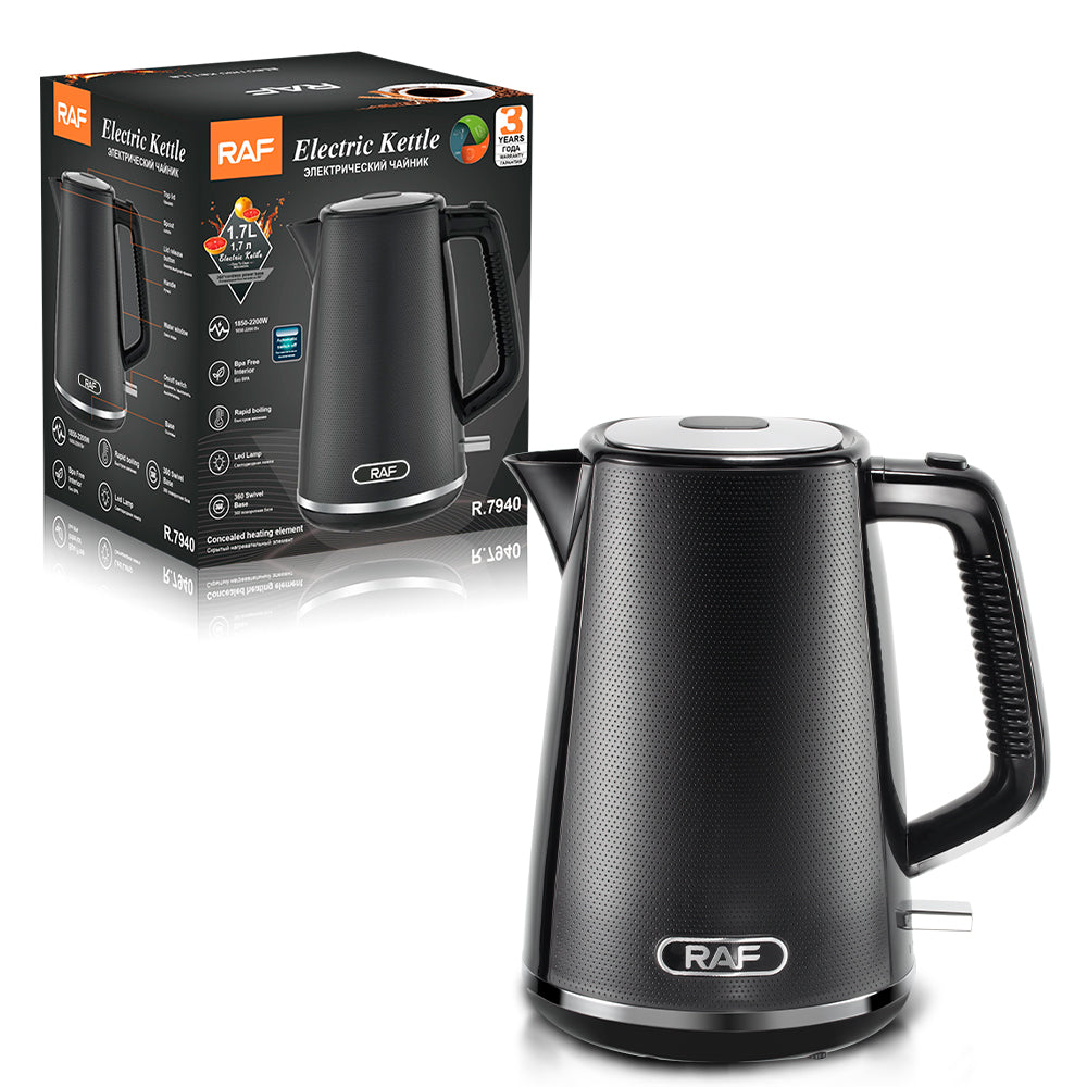 Black electric kettle with RAF branding next to its packaging on a white background